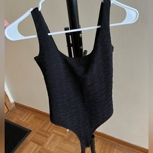 Low back, black body suit